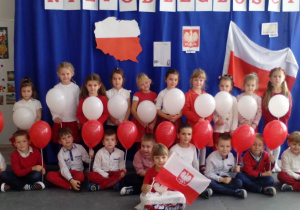 Dzieci ustawione do zdjęcia, tworzące flagę Polski z balonów biało-czerwonych,